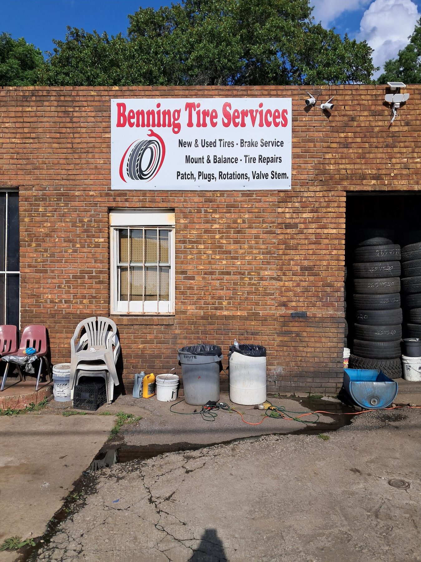 Custom Benning Tire Services business sign installed on a brick building