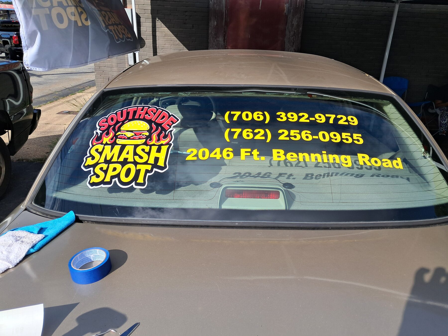 Custom business lettering installed on a vehicle rear window